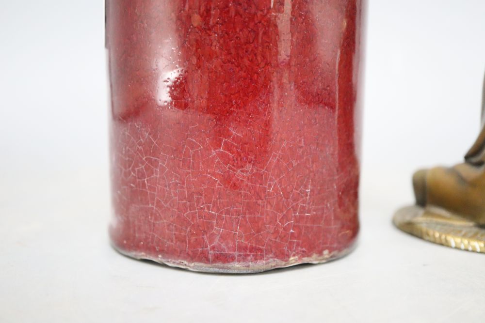 A sang de boeuf brush pot, height 15cm and a bronze deity
